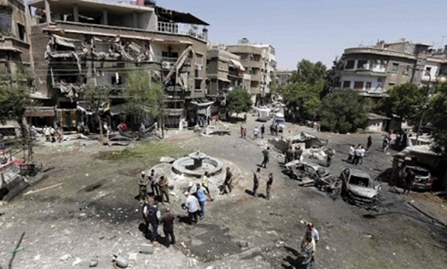 Syrians inspect the site of a suicide bomb attack in the capital Damascus' eastern Tahrir Square district, on July 2, 2017 (Photo: AFP)
