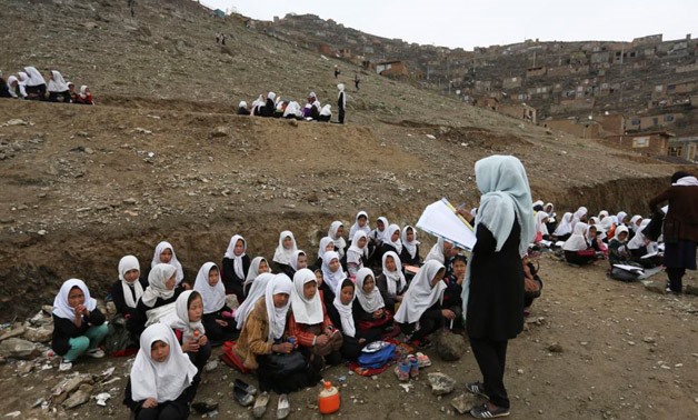 FILE - Afghan students attend school classes in an open-air primary school CC