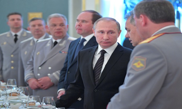 Russian President Vladimir Putin and Defence Minister Sergei Shoigu attend a reception ceremony for graduates, teachers and heads of military universities at the Kremlin in Moscow, Russia, June 28, 2017. Sputnik/Alexei Druzhinin/Kremlin