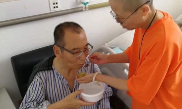  Liu Xiaobo is attended to by his wife Liu Xia in a hospital in China. Photograph: AFP