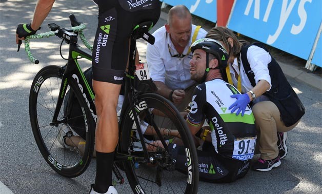 Mark Cavendish of Britain gets medical assistance after his crash next to the finish line - REUTERS