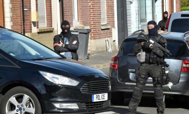 Police officers of an anti-terrorism unit and of French intelligence agency (DGSI) patrol in a street on Wattignies, northern France, after a man was arrested  - AFP