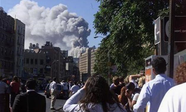 People watch as the second World  Trade 
Center towers collapse  on September 11, 2001