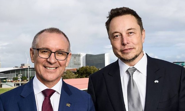 A handout photo taken and received on July 7, 2017, shows South Australia's Premier Jay Weatherill (L) and Tesla Motors CEO Elon Musk (R) - AFP/Handout
