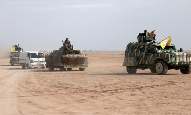 FILE PHOTO: Syrian Democratic Forces (SDF) fighters ride on vehicles in the north of Raqqa city, Syria February 5, 2017. REUTERS
