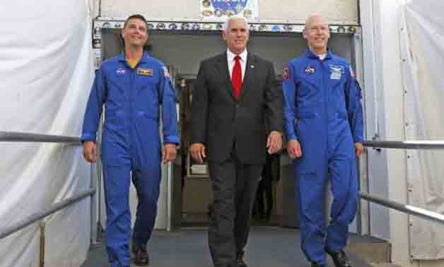 Vice President Mike Pence, center, is flanked by NASA astronaut Reid Wiseman, left, and Patrick Forrester, NASA Chief astronaut as they walk out of crew headquarters at the Kennedy Space Center in Cape Canaveral, Florida, on Thursday, July 6, 2017. Pence 