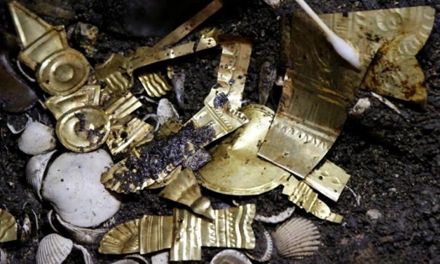 Gold pieces formed into symbols are seen at a site where a sacrificed young wolf elaborately adorned with some of the finest Aztec gold has been discovered, adjacent to the Templo Mayor, one of the main Aztec temples, in Mexico City, Mexico June 22, 2017.