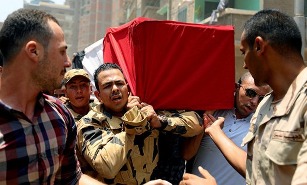 Egyptian relatives and friends carry the coffin of the officer Khaled al-Maghrabi, who was killed during a suicide bomb attack on an army checkpoint in Sinai, during his funeral in his hometown Toukh, Al Qalyubia Governorate, north of Cairo, Egypt 8 July,