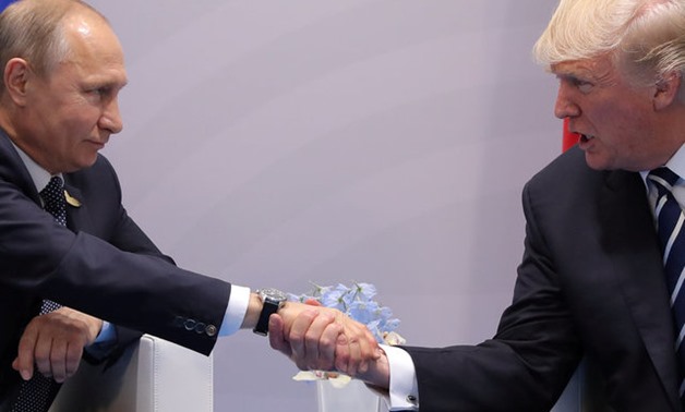 U.S. President Donald Trump shakes hands with Russian President Vladimir Putin during their bilateral meeting at the G20 summit in Hamburg, Germany July 7, 2017. REUTERS/Carlos Barria
