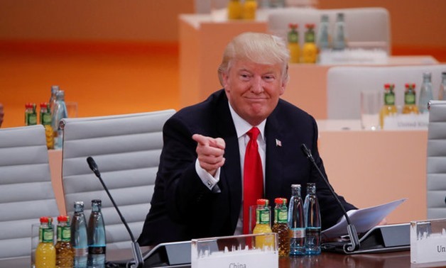 U.S. President Donald Trump gestures as he sits at the table during a working session at the G20 leaders summit in Hamburg, Germany July 8, 2017. REUTERS/Wolfgang Rattay
