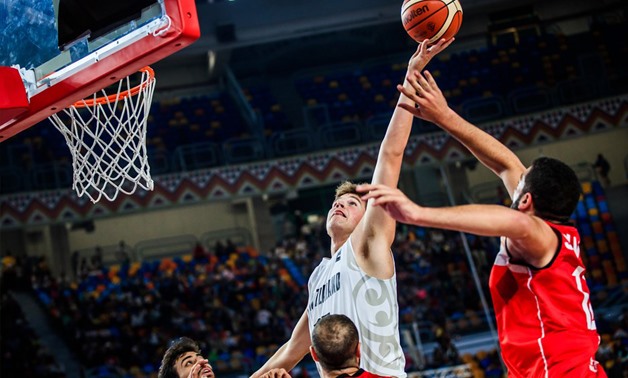 New Zealand player Samuel Waardenburg scoring over the Egyptian defense - Press image courtesy FIBA official website.