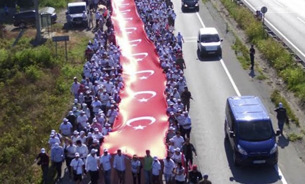 © Ziya Koseoglu, AFP | Thousands of protesters hold a 1,100 meters-long national flag at the CHP Justice March on July 1, 2017.
