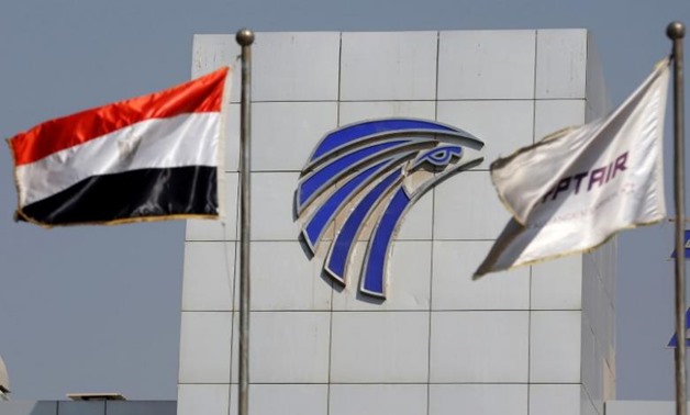 Egypt and EgyptAir flags are seen in front of an EgyptAir in-flight service building - Reuters