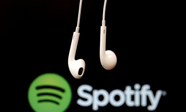 FILE PHOTO: Headphones are seen in front of a logo of online music streaming service Spotify, February 18, 2014
