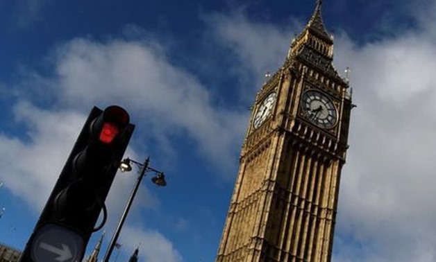 A red traffic light is seen next to Big Ben, in Westminster, central London, Britain, June 9, 2017.
