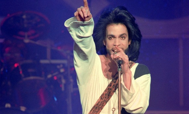 Musician Prince performing on stage during his 1990 concert at the Parc des Princes stadium in Paris