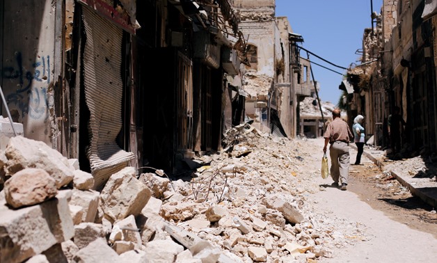 A man walks past damaged houses in the old city of Aleppo, Syria July 13, 2017. REUTERS/Omar Sanadiki