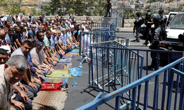 Palestinians pray outside al-Qods after Israeli forces barred them from entering the Old City- Reuters