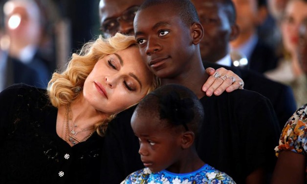 US singer Madonna embraces her adopted son, David Banda ahead of the opening of the Mercy James hospital in Blantyre, Malawi, July 11,2017. Reuters/Siphiwe Sibeko