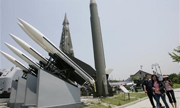 Foreign visitors walk past models of a North Korean Scud-B missile- Reuters