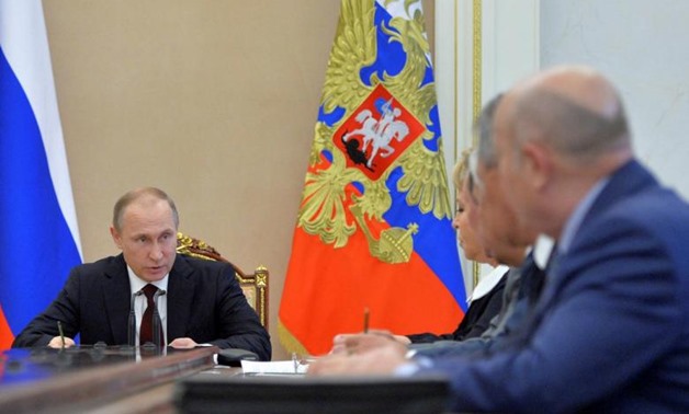 Russian President Vladimir Putin chairs a meeting with members of the Security Council at the Kremlin - Reuters