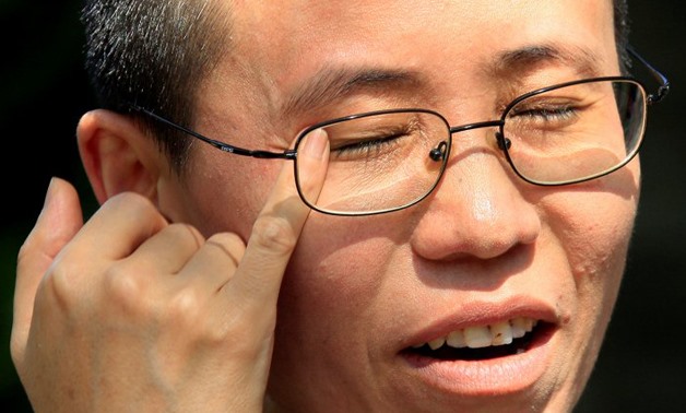 Liu Xia, wife of veteran Chinese pro-democracy activist Liu Xiaobo, wipes her eyes as she speaks during an interview in Beijing June 24, 2009. REUTERS/David Gray/File Photo
