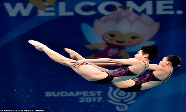 Qian Ren and Yajie Si of China compete in women's diving 10m synchronized platform final at the Swimming World Championships in Duna Arena in Budapest, Hungary, Sunday, July 16, 2017. (Zoltan Mathe /MTI via AP)