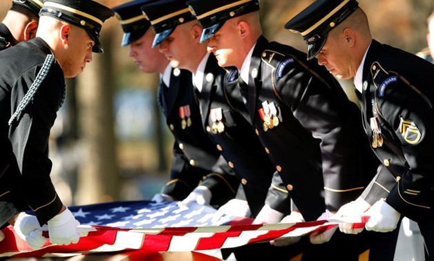 The casket team readies the U.S. flag for folding and presentation during a full honors funeral service held for U.S Army Staff Sergeant James Moriarty at Arlington National Cemetery Virginia, U.S., December 5, 2016. On Tuesday, a Jordanian soldier charge