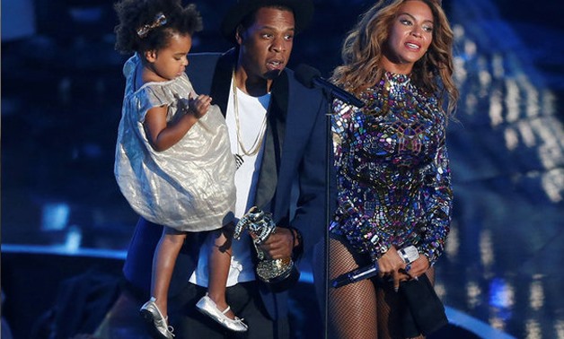 Jay-Z presents the Video Vanguard Award to his wife Beyonce as he holds their daughter Blue Ivy during the 2014 MTV Video Music Awards in Inglewood, California August 24, 2014. REUTERS/Mario Anzuoni/File Photo
