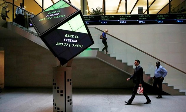 People walk through the lobby of the London Stock Exchange in London, Britain August 25, 2015.
