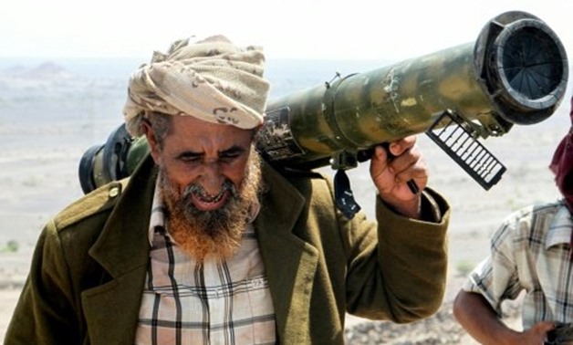  A Yemeni fighter loyal to the Saudi-backed Yemeni president holds a rocket launcher on his shoulder at a position which was taken from Shiite-Huthi rebels in a mountainous region northwest of the central city of Taez, on April 20, 2017 - AFP