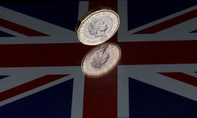 A one pound coin lies on a Union Flag in this picture illustration shot on May 3, 2017 - Reuters

