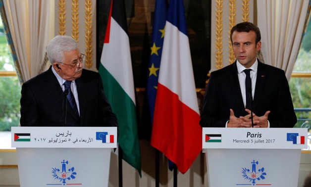 French President Emmanuel Macron and Palestinian President Mahmoud Abbas attend a joint statement after a meeting at the Elysee Palace in Paris - Reuters