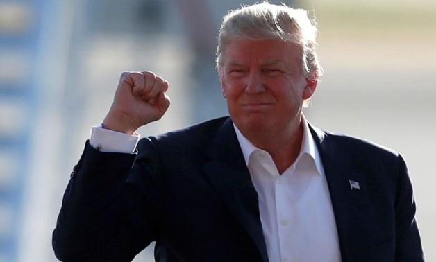 U.S. Republican presidential candidate Donald Trump pumps his fist as he arrives to speak at a campaign rally in Sacramento, California, U.S. June 1, 2016.