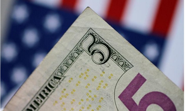 A U.S. five dollar note is seen in this picture illustration - Reuters/Thomas White/Illustration