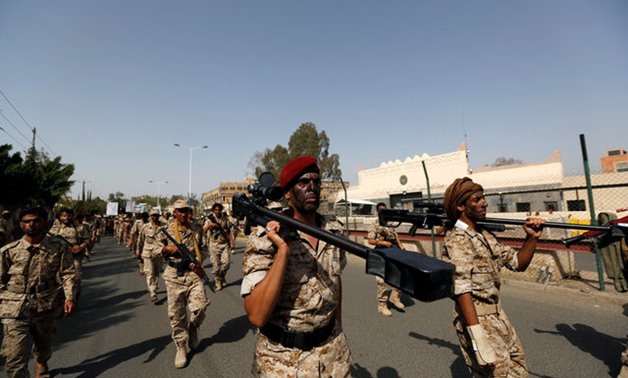 Newly recruited fighters parade outside the U.S. embassy before they join Houthi rebels in the battles frontline at the border with Saudi Arabia and in other parts of Yemen, in the capital Sanaa - Reuters