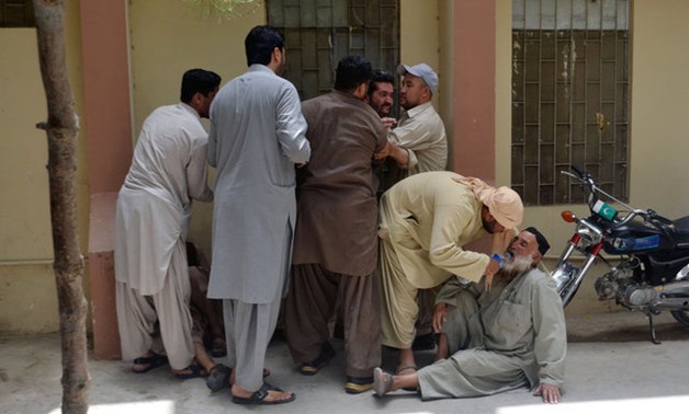 Relatives react outside the hospital after policemen were shot dead in Quetta - Reuters