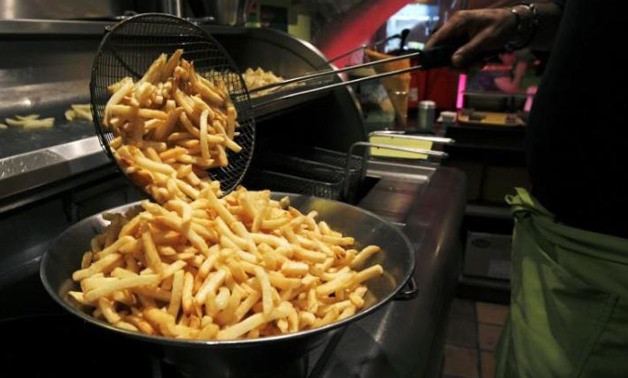  A cook prepares fries in a cafe at the Frietmuseum in Bruges September 27, 2011 - Reuters