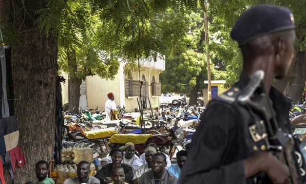 © Reinnier Kaze, AFP | A Cameroonian policeman patrols as Muslims attend the Friday prayer in Maroua, in the extreme northern province, west of the Nigerian border, on September 16, 2016.
