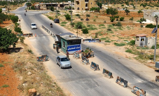 Members from a coalition of rebel groups called "Jaish al Fateh", also known as "Army of Fatah" (Conquest Army), man a checkpoint in Idlib city