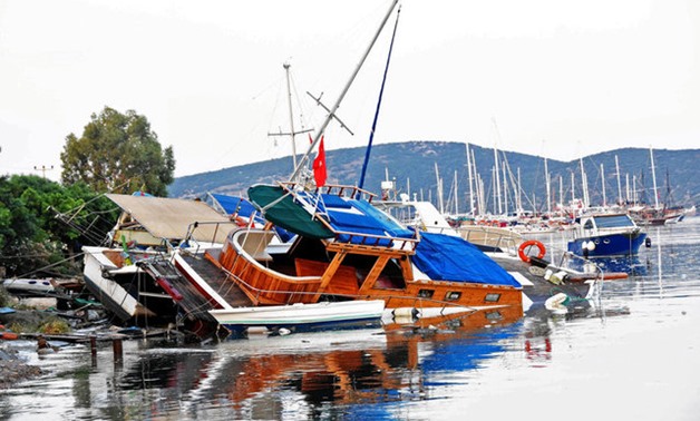 FILE- Damaged boats are seen after an earthquake and a tsunami in the resort town of Gumbet in Mugla province -Reuters