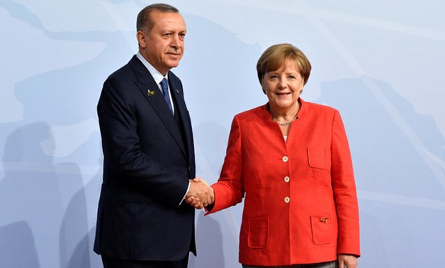 German Chancellor Angela Merkel greets Turkey's President Recep Tayyip Erdogan at the beginning of the G20 summit in Hamburg, Germany, July 7, 2017. REUTERS