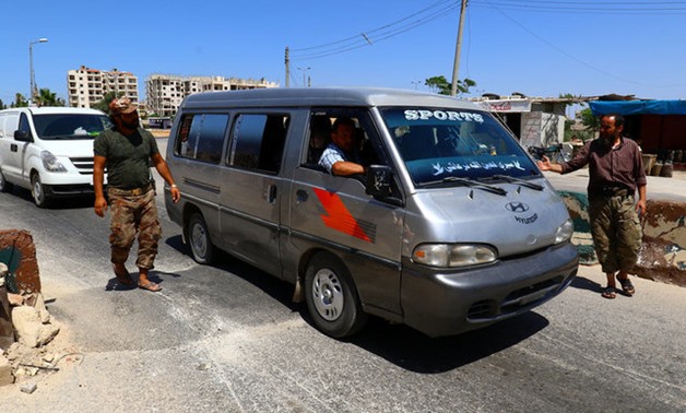 Members from a coalition of rebel groups called "Jaish al Fateh", also known as "Army of Fatah" (Conquest Army), man a checkpoint in Idlib city - Reuters