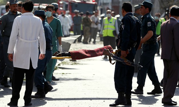 Afghan policemen carry the dead body of a victim at the site of a suicide attack in Kabul, Afghanistan, July 24, 2017.REUTERS/Omar Sobhani TEMPLATE OUT