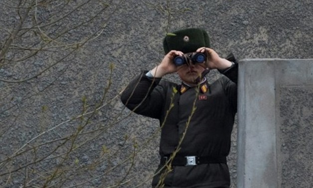 © AFP/File | A North Korean soldier gazes across the Yalu border river near Sinuiju, opposite the Chinese city of Dandong, on April 14, 2017
