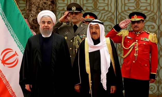 Presidency, President Hassan Rouhani, left, is welcomed by Kuwaiti Emir Sheikh Sabah Al Ahmed Al Sabah, center, at the Kuwait International Airport - AP