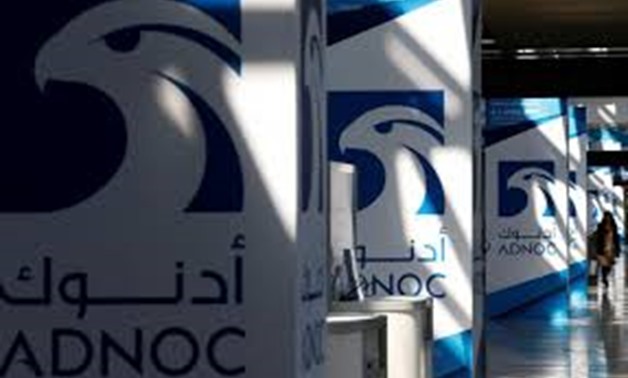 FILE PHOTO: Logos of ADNOC are seen at Gastech, the world's biggest expo for the gas industry, in Chiba, Japan, April 4, 2017.
