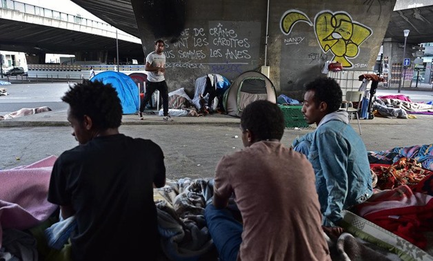 Migrants sitting at Porte de La Chapelle in Paris on 29 June 2017.
