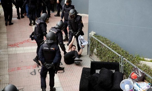 Spanish riot policemen drag away an activist in Parla, Spain February 16, 2017.
