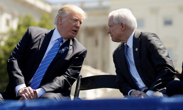 President Donald Trump speaks with Attorney General Jeff Sessions on the West Lawn of the U.S. Capitol in Washington - Reuters